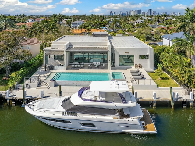 back of house with a patio area, a water view, and an outdoor living space