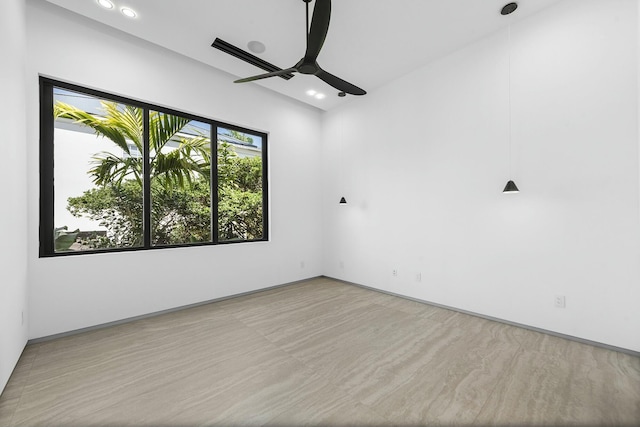 spare room featuring ceiling fan and light wood-type flooring