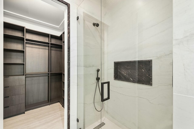 bathroom featuring walk in shower and hardwood / wood-style floors