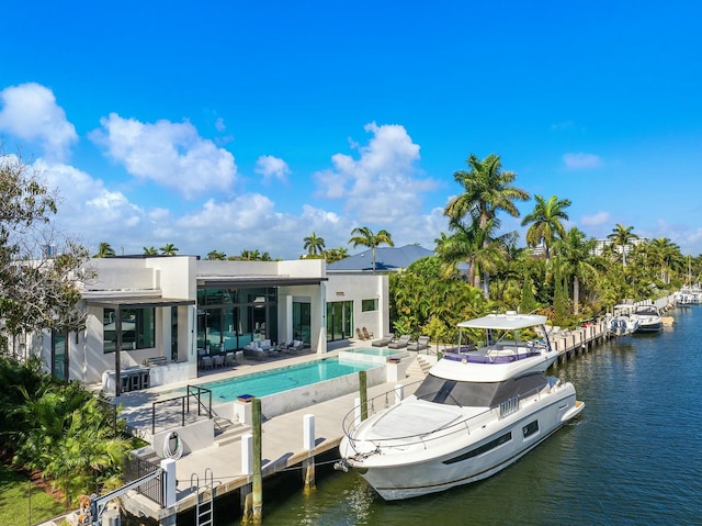 back of property featuring a water view and a patio area