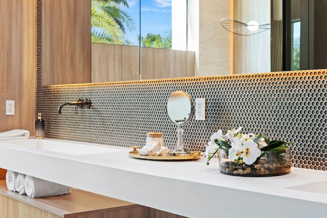 bathroom featuring vanity and backsplash