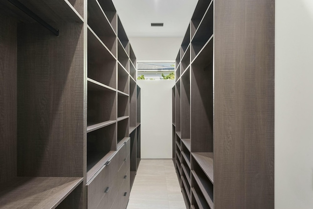 spacious closet featuring light tile patterned floors