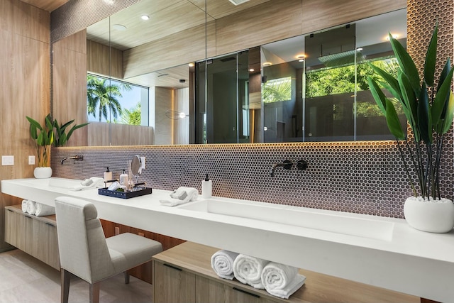 bathroom with vanity and tasteful backsplash