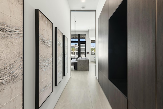 hall featuring light tile patterned flooring