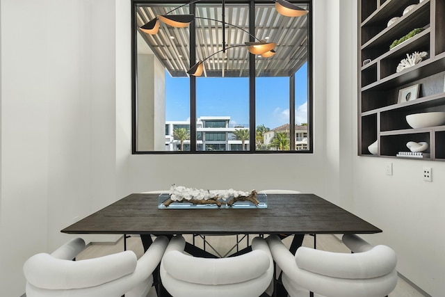 dining room featuring breakfast area and a notable chandelier