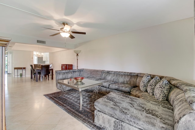 living room featuring ceiling fan with notable chandelier