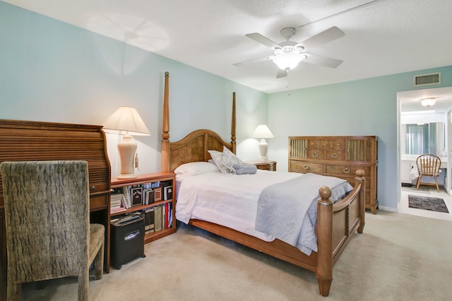 carpeted bedroom with a textured ceiling and ceiling fan