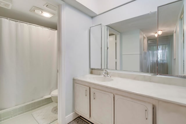 bathroom with vanity, toilet, and tile patterned flooring