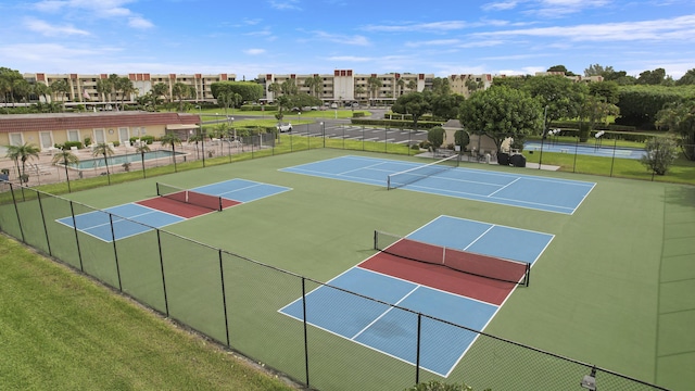 view of tennis court with fence