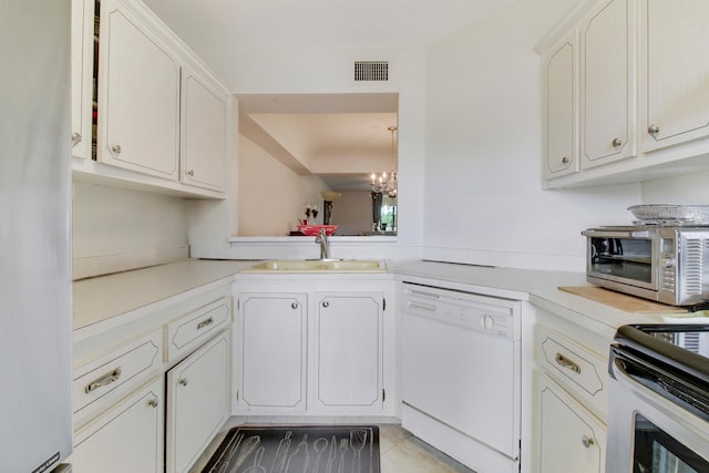 kitchen with white dishwasher, sink, white cabinetry, and a notable chandelier