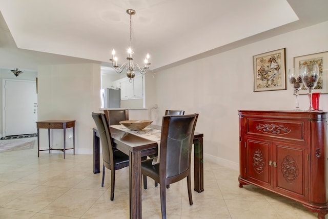 tiled dining room with a chandelier