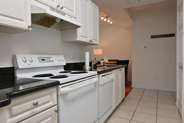 kitchen with white cabinetry, sink, white appliances, and light tile patterned flooring