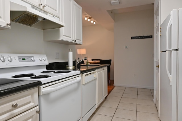 kitchen featuring white appliances, white cabinetry, sink, and light tile patterned flooring