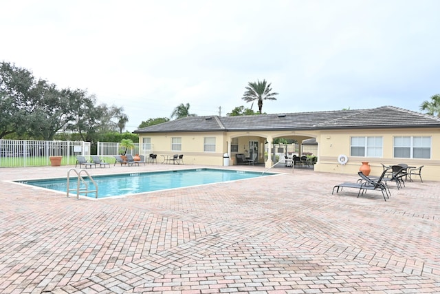 view of swimming pool with a patio area