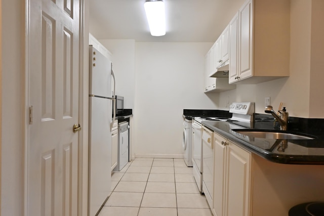 kitchen featuring white appliances, light tile patterned floors, sink, white cabinets, and kitchen peninsula