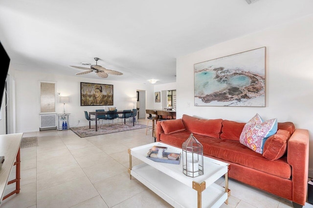 living room with ceiling fan and light tile patterned floors