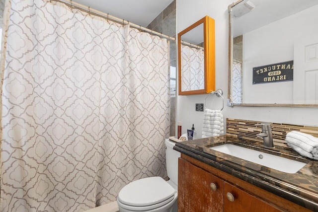 bathroom featuring vanity, tasteful backsplash, and toilet