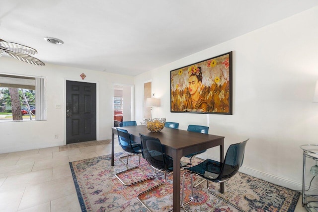 dining space featuring light tile patterned floors