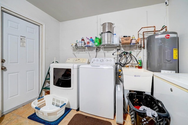 clothes washing area with washing machine and dryer, electric water heater, sink, and light tile patterned floors