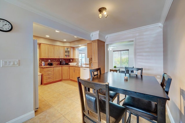 dining room with sink, light tile patterned floors, and ornamental molding