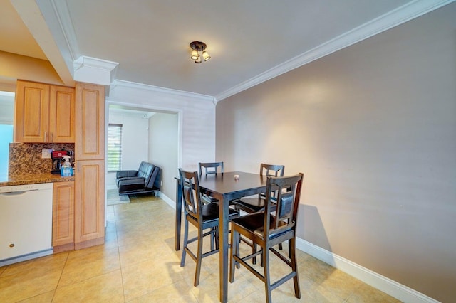 dining space with ornamental molding and light tile patterned floors