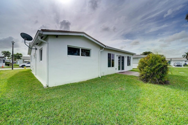 rear view of house with a yard