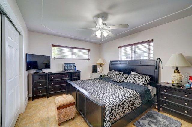 tiled bedroom with a closet and ceiling fan