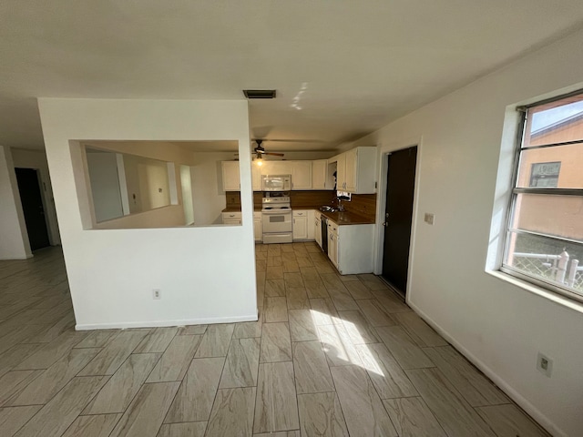 kitchen with white cabinets, white appliances, ceiling fan, and sink