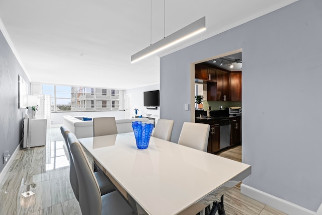 dining space with sink and ornamental molding