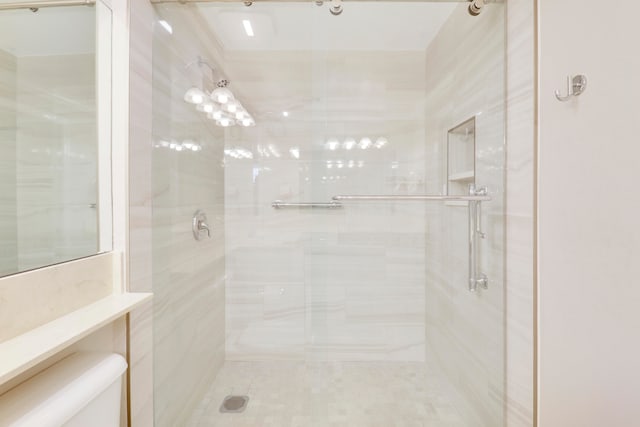 bathroom featuring toilet and an enclosed shower