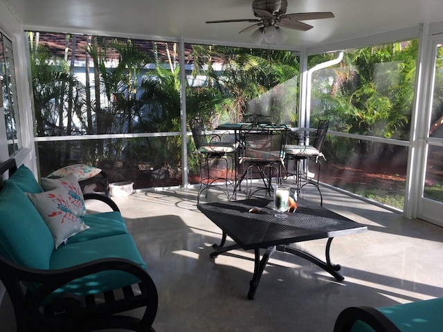 sunroom featuring ceiling fan