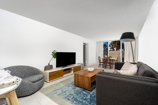 living room with tile patterned flooring and a textured ceiling