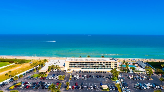 bird's eye view featuring a view of the beach and a water view