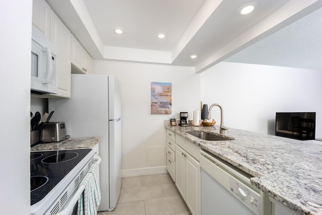 kitchen with sink, light stone counters, light tile patterned floors, white appliances, and white cabinets