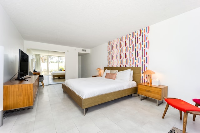 bedroom featuring a textured ceiling and light tile patterned floors