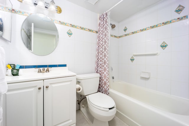 full bathroom with tile patterned flooring, shower / tub combo, vanity, toilet, and tile walls