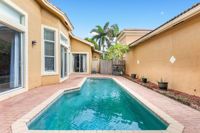 view of swimming pool featuring a patio