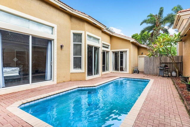 view of pool with a patio area and grilling area