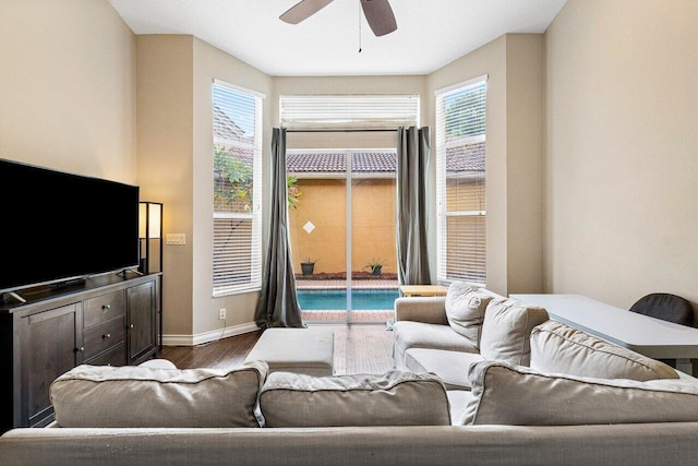 living room with ceiling fan, dark hardwood / wood-style floors, and plenty of natural light