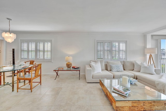 tiled living room with plenty of natural light, ornamental molding, and an inviting chandelier