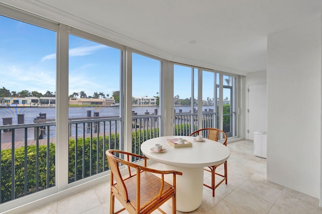 sunroom / solarium with a water view