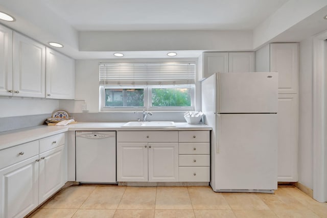 kitchen featuring sink, white cabinets, light tile patterned flooring, and white appliances