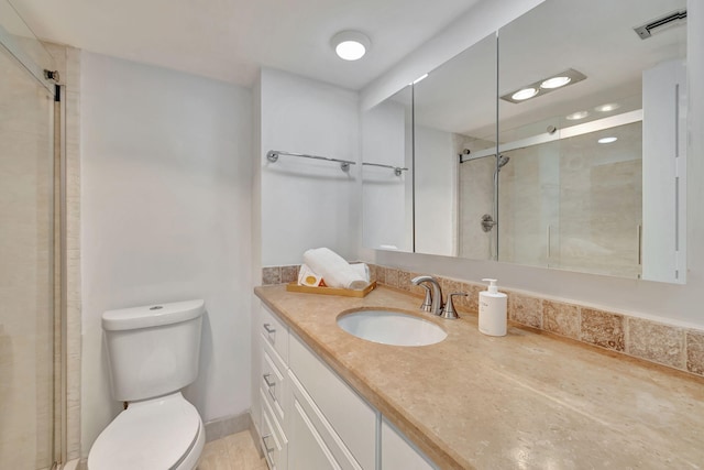 bathroom featuring vanity, toilet, and a shower with door