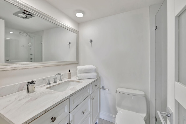 bathroom featuring vanity, toilet, and walk in shower