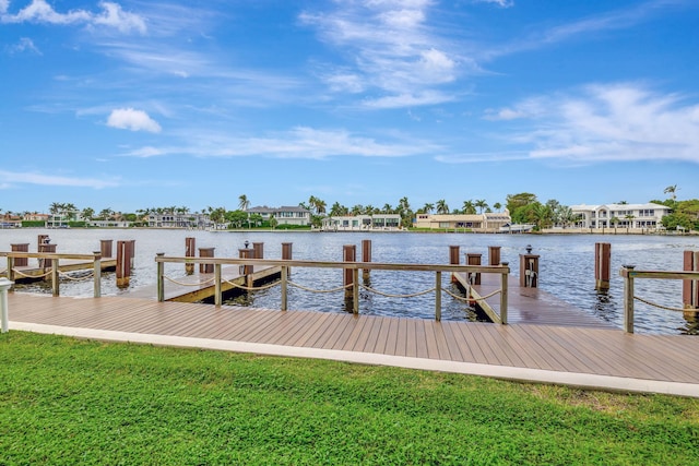 view of dock with a water view and a lawn