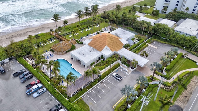 birds eye view of property with a water view and a beach view