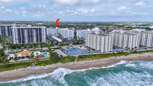 drone / aerial view featuring a view of the beach and a water view