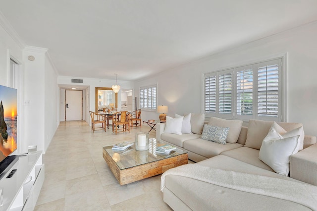 living room featuring light tile patterned floors and ornamental molding