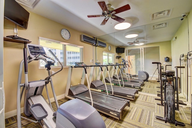 gym featuring ceiling fan and a healthy amount of sunlight