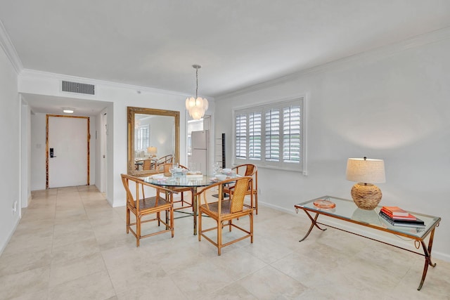 tiled dining space featuring ornamental molding and a chandelier